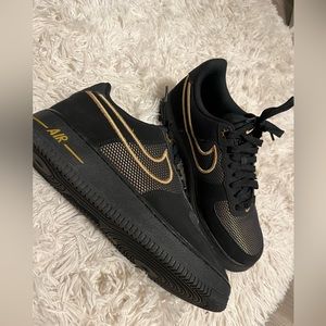 Women’s size 10 black and gold Nike Air Force 1